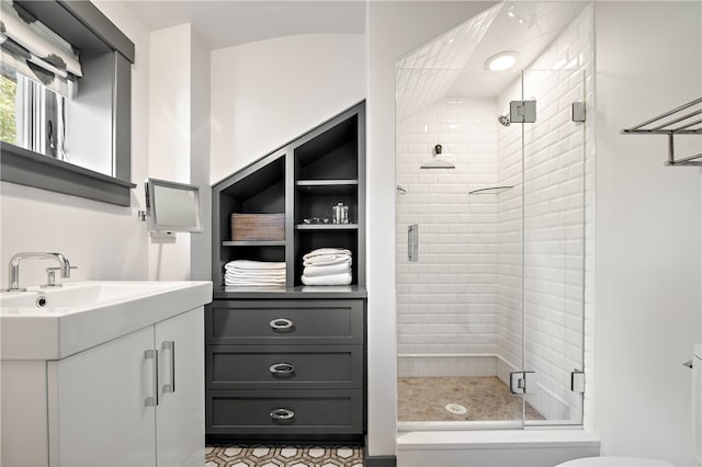 bathroom featuring vanity, tile patterned floors, a shower with door, and toilet