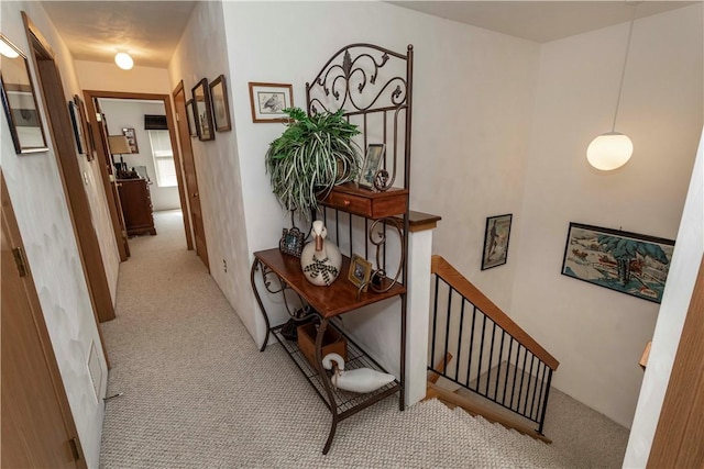 hallway featuring light carpet