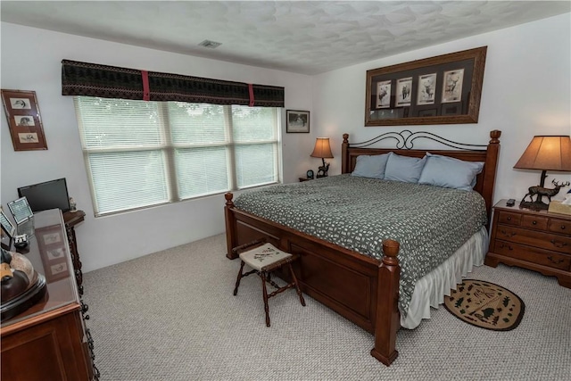 carpeted bedroom featuring a textured ceiling