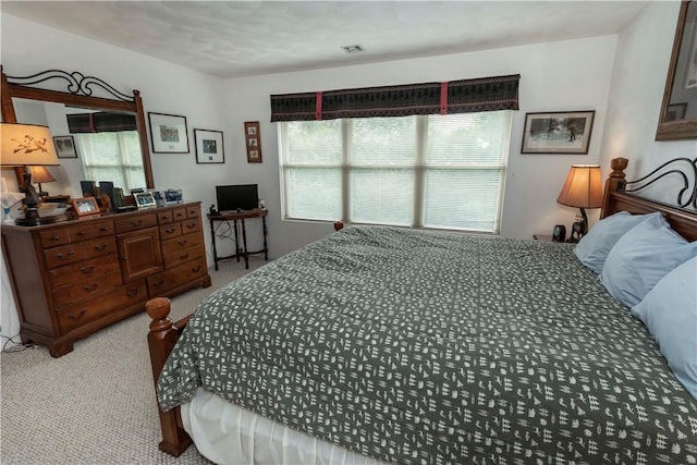 bedroom featuring light colored carpet