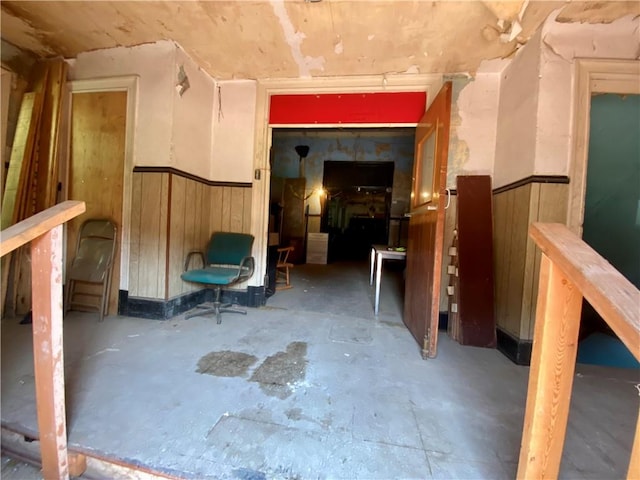 812 Concord St, East Allegheny, PA 15212 - hall featuring unfinished concrete floors, a wainscoted wall, and wood walls
