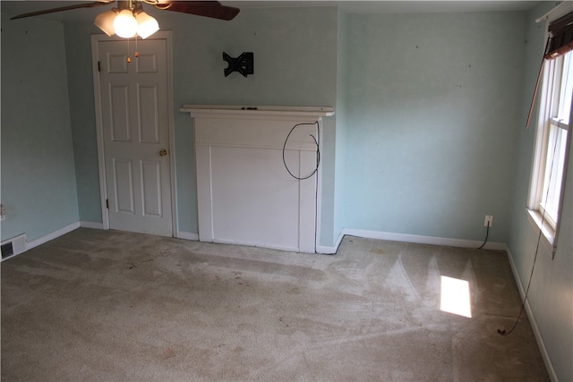 unfurnished living room featuring carpet flooring and ceiling fan