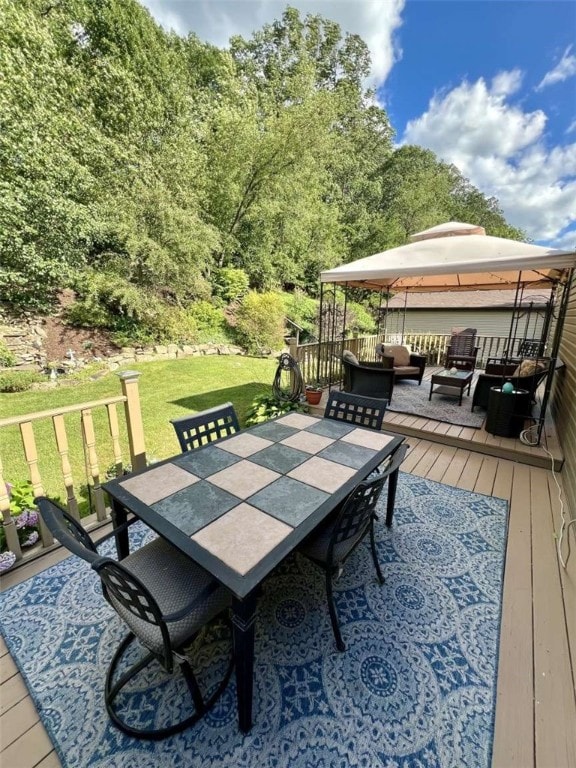 deck featuring an outdoor living space, a yard, and a gazebo