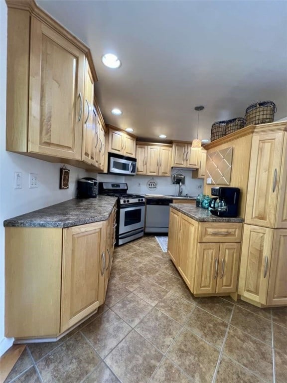 kitchen with pendant lighting, tile patterned flooring, light brown cabinets, and stainless steel appliances