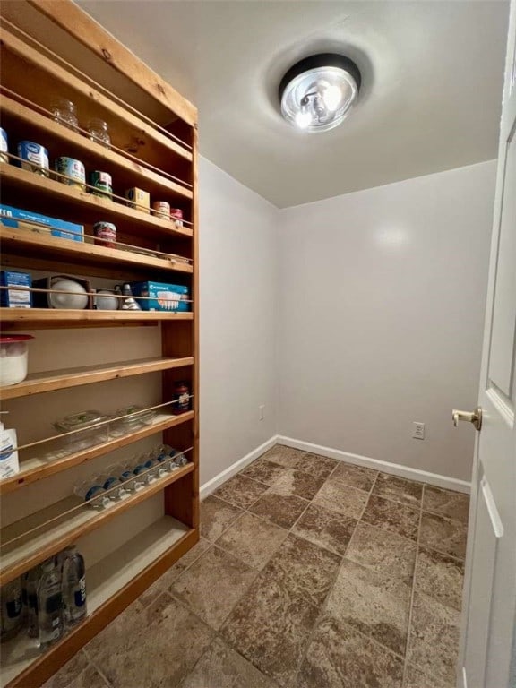 walk in closet featuring dark tile patterned flooring