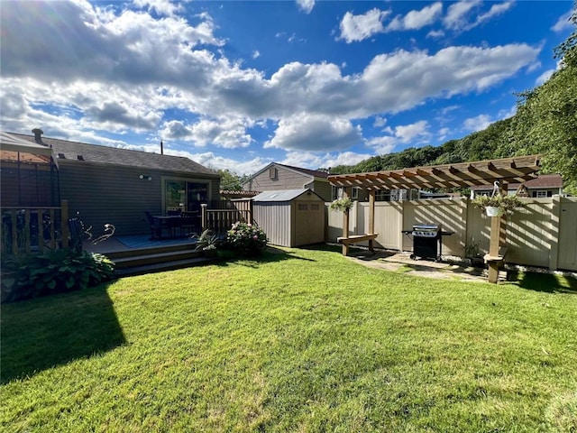 view of yard with a pergola, a storage unit, and a deck