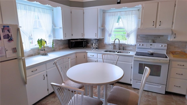 kitchen featuring white cabinetry, white range with electric stovetop, fridge, and backsplash