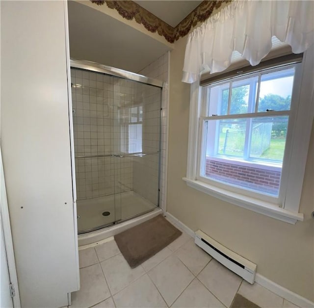 bathroom featuring baseboard heating, tile patterned flooring, and a shower with door