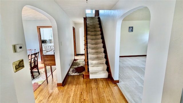 staircase featuring light wood-type flooring