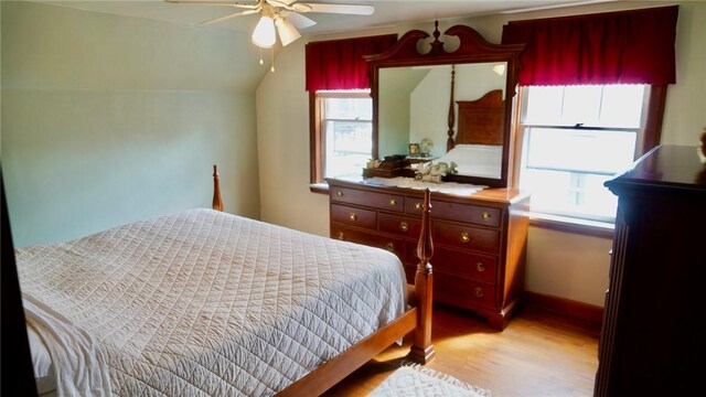 bedroom with lofted ceiling, light wood-type flooring, and ceiling fan