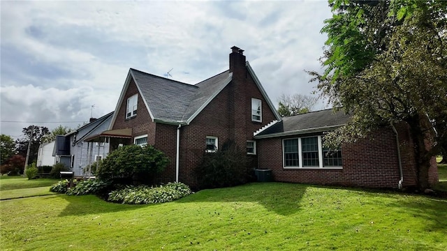 view of home's exterior featuring a lawn and cooling unit