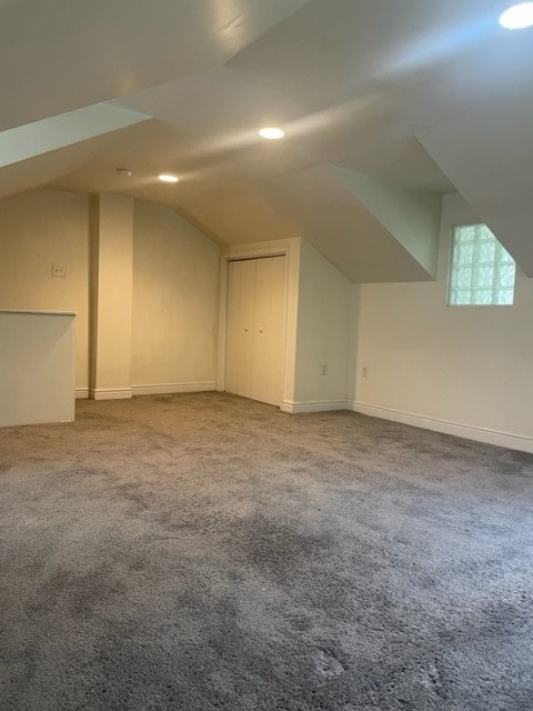 bonus room featuring light carpet and vaulted ceiling