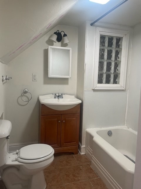 full bathroom featuring lofted ceiling, washtub / shower combination, toilet, vanity, and tile patterned floors