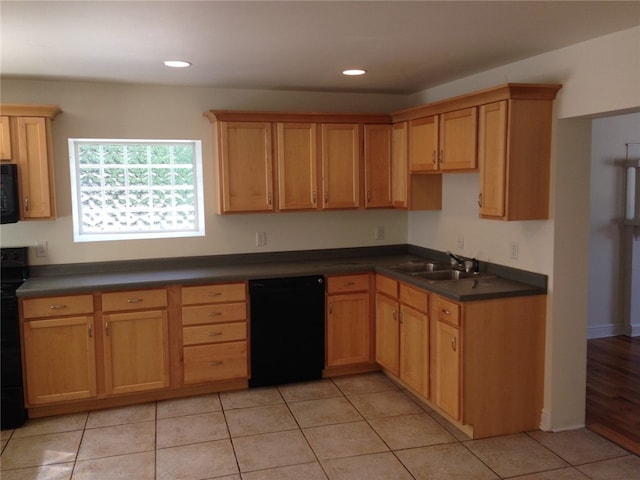 kitchen with light hardwood / wood-style floors, black appliances, and sink