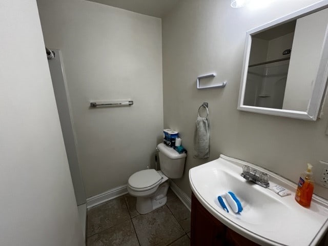 bathroom featuring vanity, toilet, and tile patterned floors