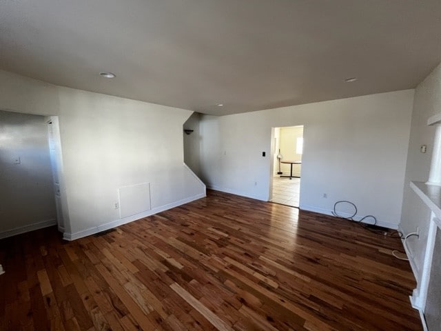 unfurnished room with dark wood-type flooring