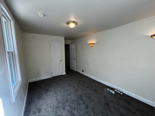 interior space featuring dark colored carpet