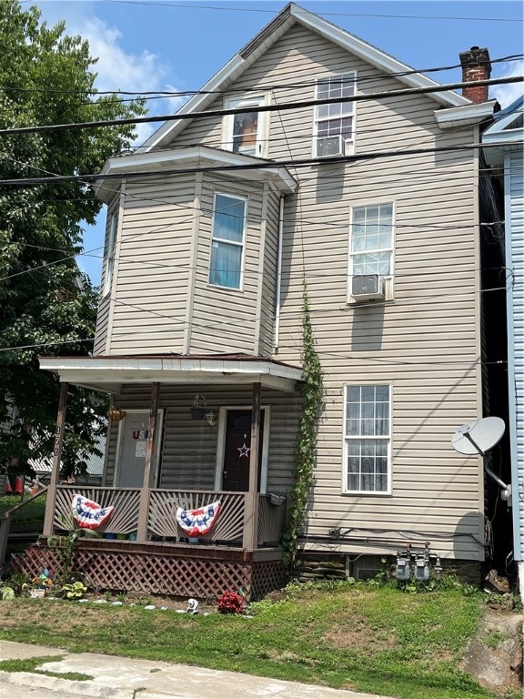 view of front of house featuring cooling unit and covered porch