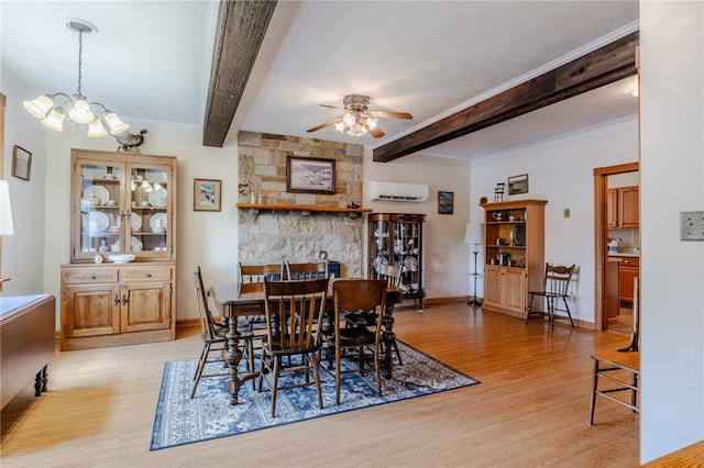 dining room with beam ceiling, ceiling fan with notable chandelier, light hardwood / wood-style floors, and an AC wall unit