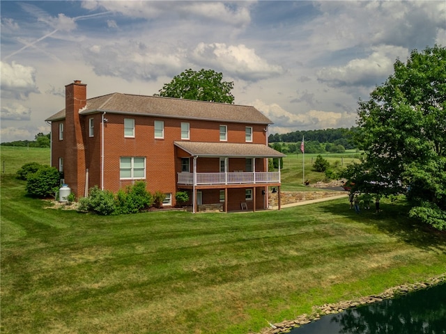 rear view of property featuring a yard