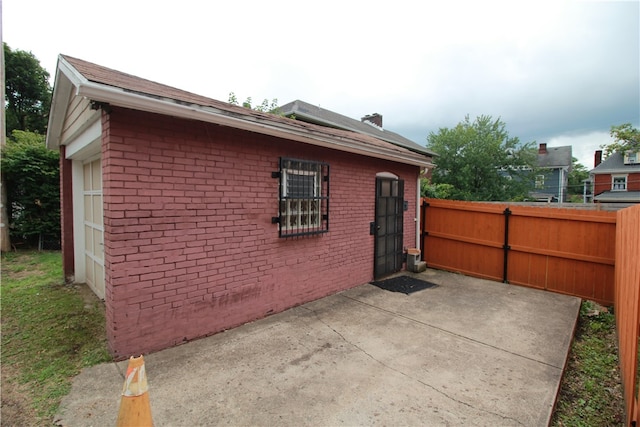 view of side of property with a garage and a patio