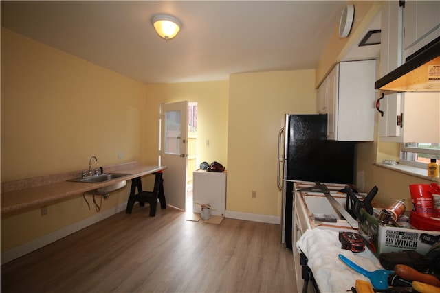 office space featuring light hardwood / wood-style flooring and sink