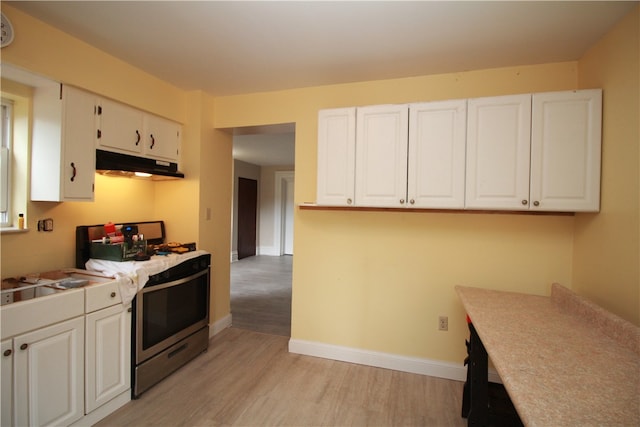 kitchen featuring light hardwood / wood-style flooring, white cabinetry, and gas stove