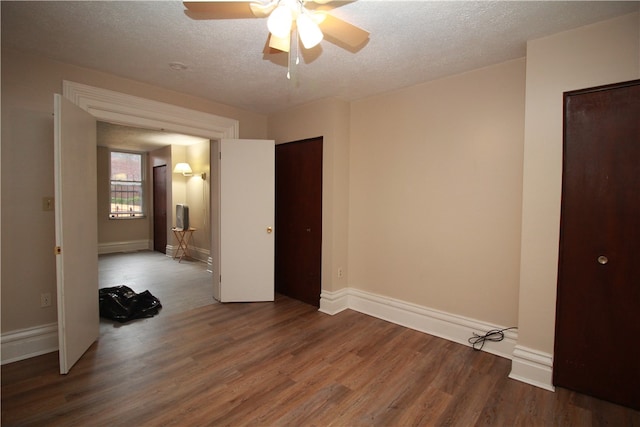 unfurnished room with a textured ceiling, hardwood / wood-style flooring, and ceiling fan