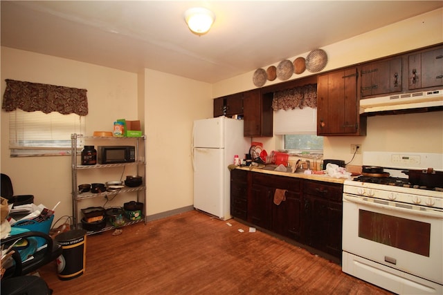 kitchen featuring dark brown cabinetry, sink, dark hardwood / wood-style floors, and white appliances