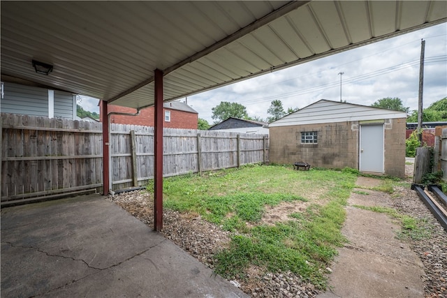 view of yard featuring an outbuilding and a patio area