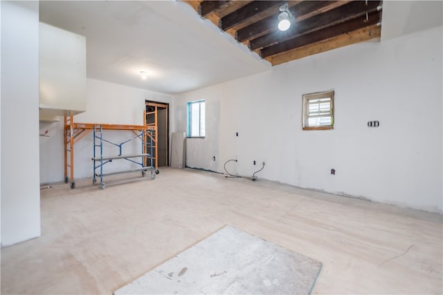 unfurnished room featuring beamed ceiling