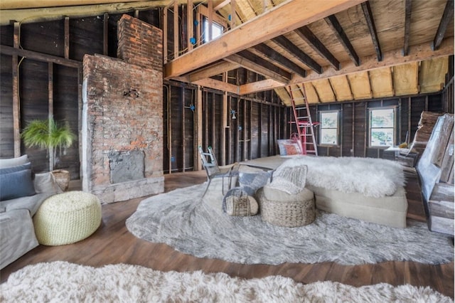 misc room with lofted ceiling with beams