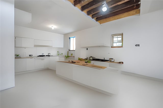 kitchen featuring white cabinets and plenty of natural light