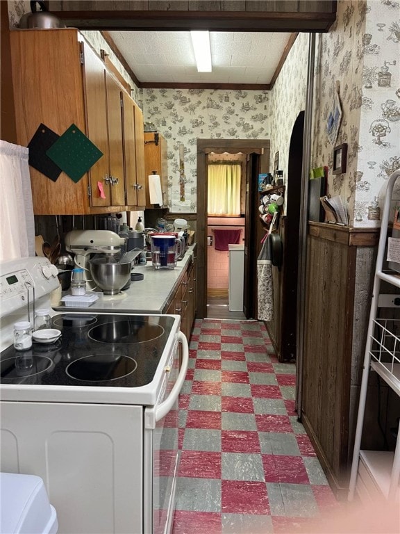 340 Mine Hill Rd, German Twp, PA 15410 - kitchen featuring brown cabinetry, light floors, wallpapered walls, light countertops, and white electric stove