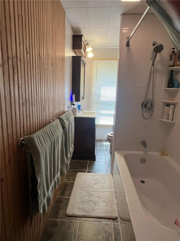 full bathroom featuring vanity, tiled shower / bath combo, toilet, and tile patterned flooring