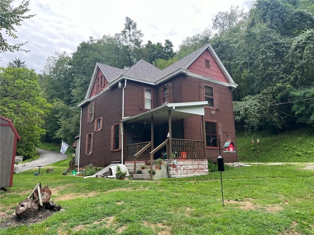 340 Mine Hill Rd, German Twp, PA 15410 - view of front of house featuring brick siding, covered porch, and a front yard