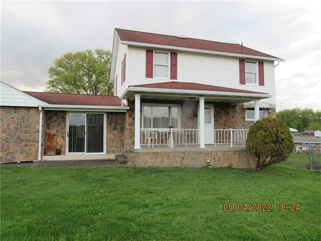 view of front of home with covered porch and a front yard