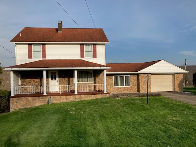 view of front of house featuring covered porch, a garage, and a front yard