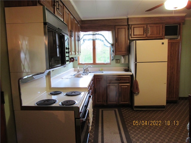 kitchen with white appliances, sink, and ceiling fan