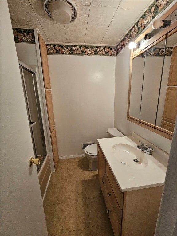 full bathroom with vanity, toilet, tile patterned floors, and enclosed tub / shower combo