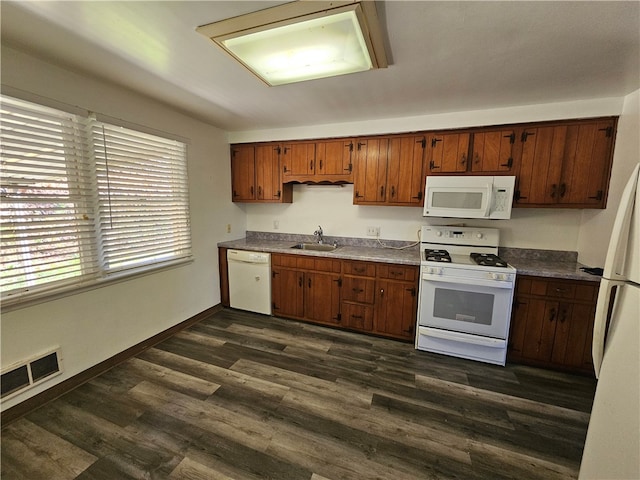 kitchen featuring dark hardwood / wood-style floors, sink, and white appliances