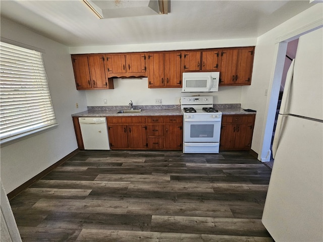 kitchen with white appliances, dark hardwood / wood-style flooring, and sink