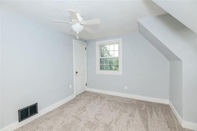 additional living space featuring light carpet, vaulted ceiling, and ceiling fan