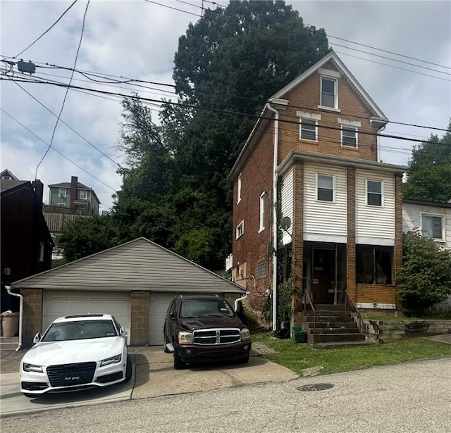 view of front of house featuring a garage and an outdoor structure