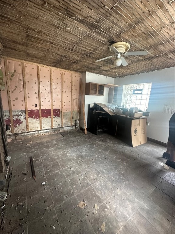 interior space featuring ceiling fan and dark tile patterned flooring