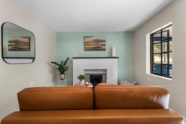 living room with a brick fireplace