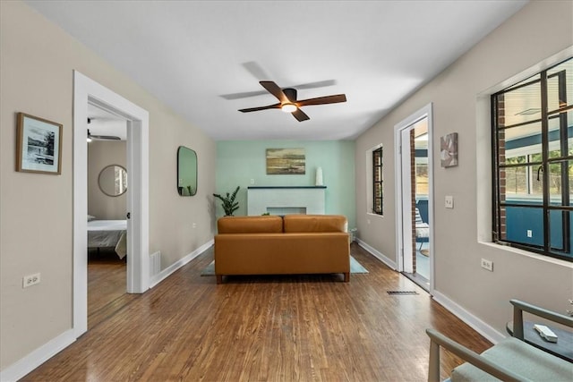 living room with hardwood / wood-style floors and ceiling fan