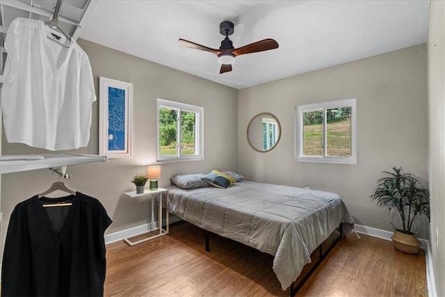 bedroom featuring hardwood / wood-style flooring and ceiling fan