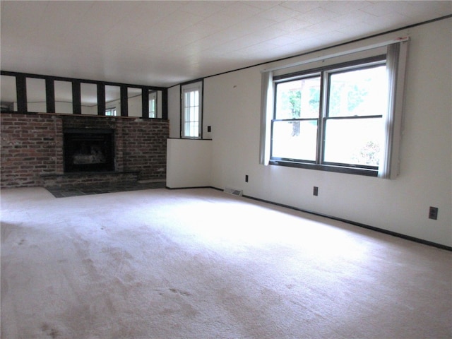 unfurnished living room featuring a fireplace and light colored carpet