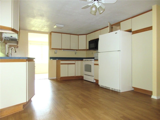 kitchen with light wood-type flooring, white appliances, ceiling fan, and cream cabinetry